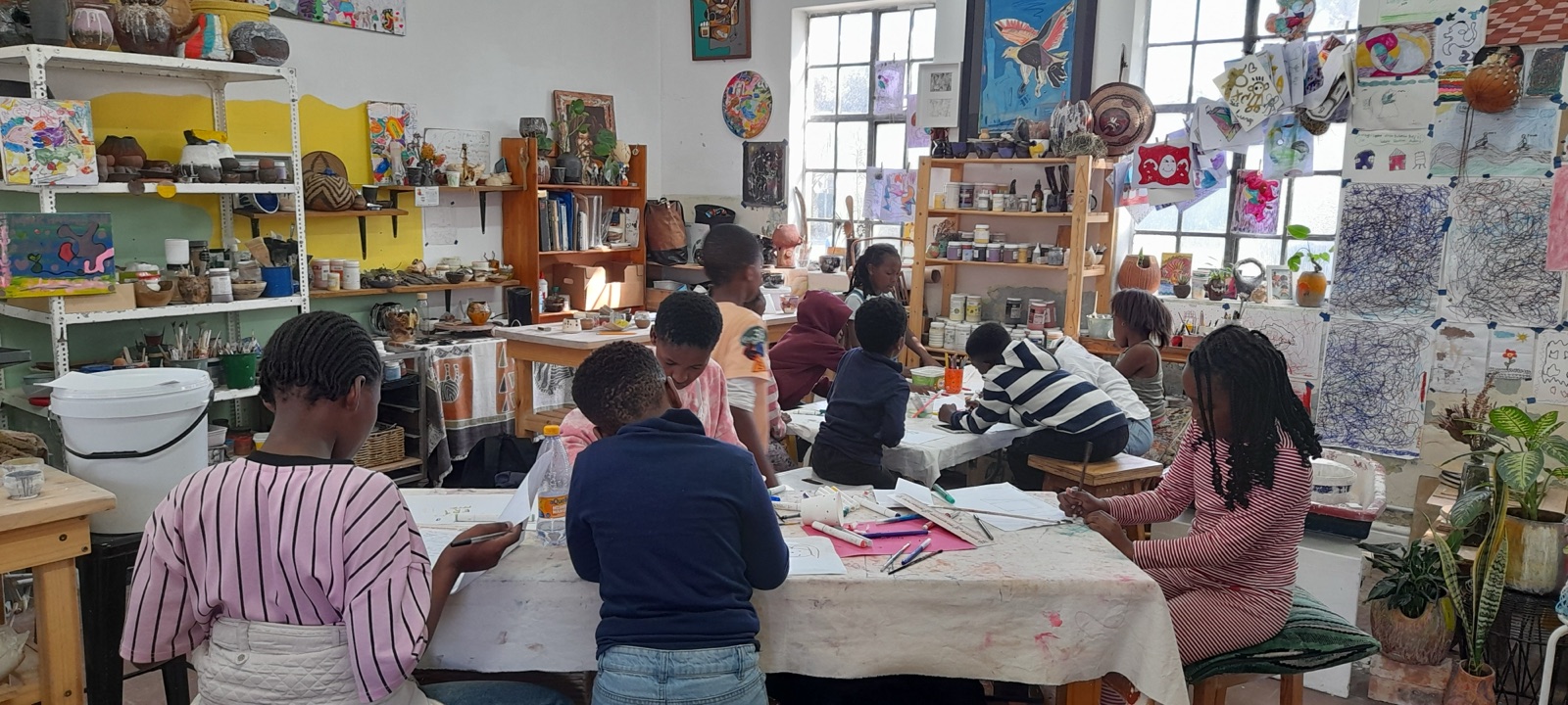 Children make art together in the busy studio