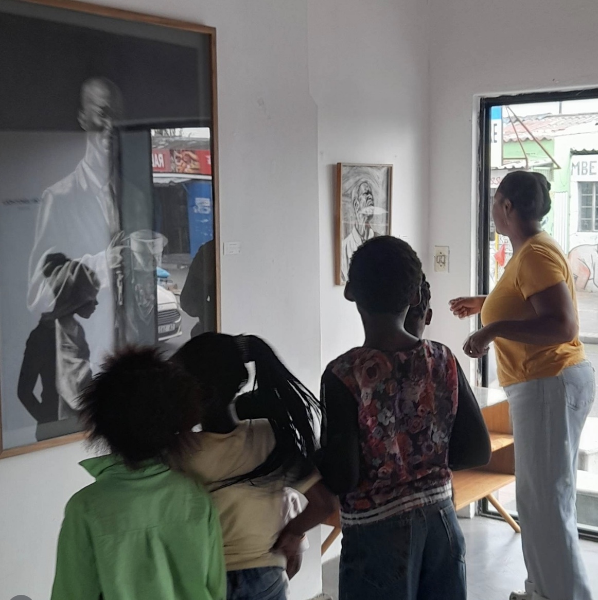 Children looking at an artwork with a gallery guide