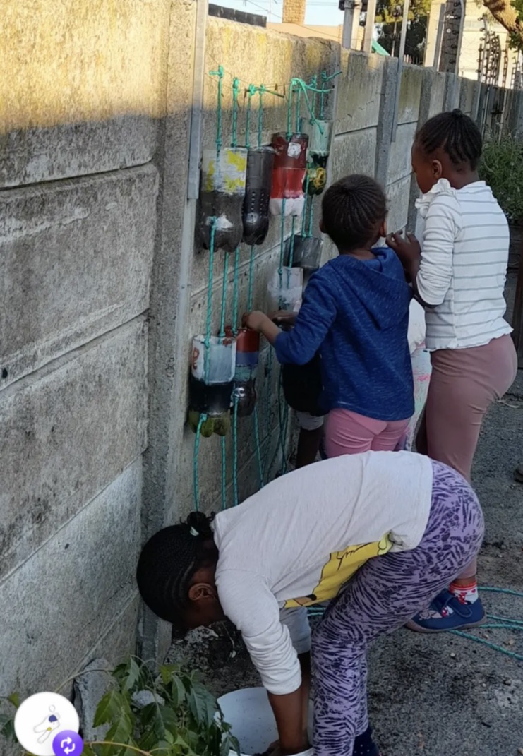 Children working together on a vertical garden