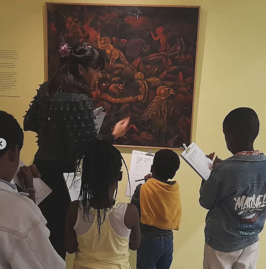 An educator sharing an artwork with children at Zeitz MOCAA